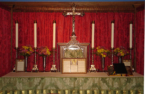 The Blessed Sacrament maintains it’s traditional place of honor on the main altar at St. Hugh The Blessed Sacrament maintains it’s traditional place of honor on the main altar at St. Hugh